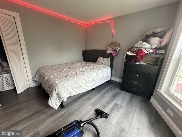 bedroom with dark wood-type flooring