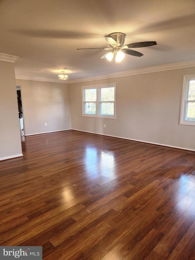 unfurnished room with dark wood-type flooring, crown molding, baseboards, and a ceiling fan