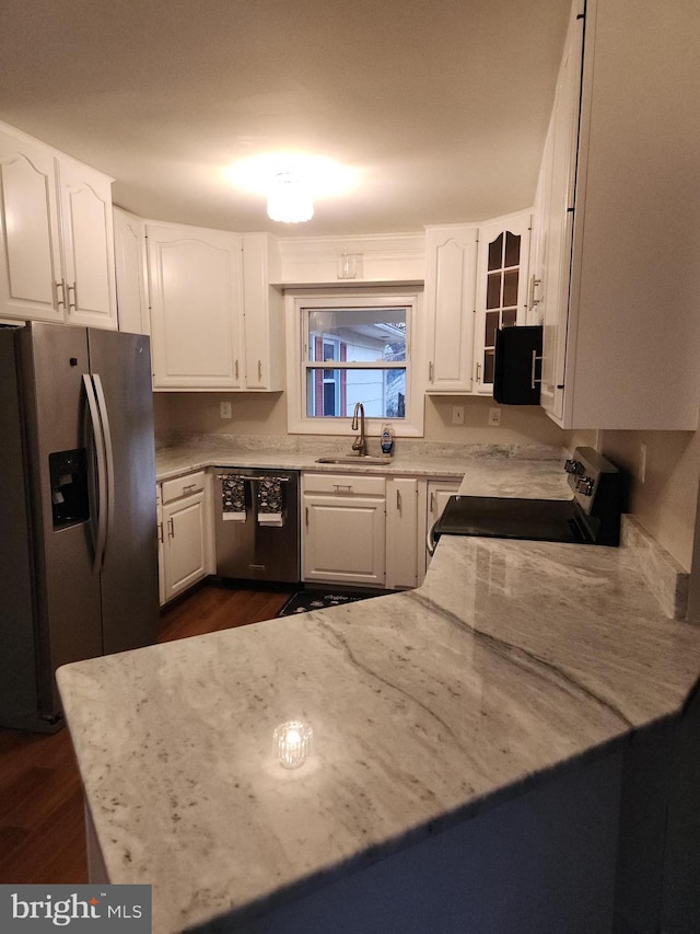 kitchen featuring dishwasher, white cabinetry, stainless steel refrigerator with ice dispenser, sink, and electric range oven