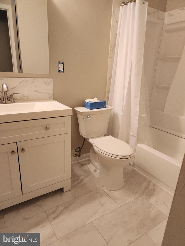 bathroom with marble finish floor, vanity, shower / bath combination with curtain, and toilet