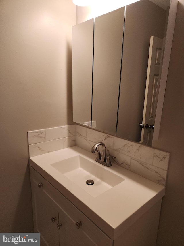 bathroom featuring decorative backsplash and vanity