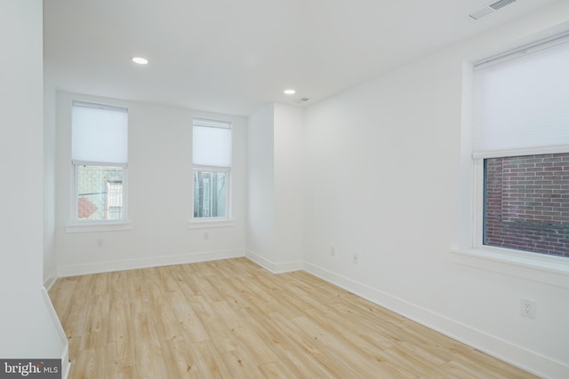 empty room with light hardwood / wood-style flooring