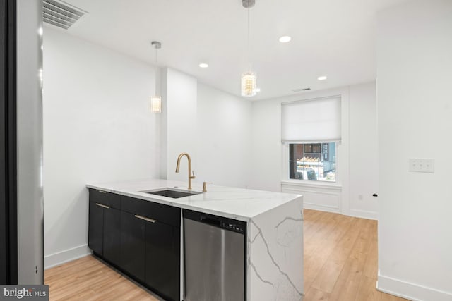 kitchen with kitchen peninsula, decorative light fixtures, dishwasher, light hardwood / wood-style flooring, and sink