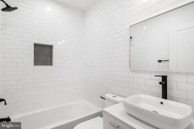 full bathroom with toilet, vanity, tile walls, backsplash, and tiled shower / bath combo