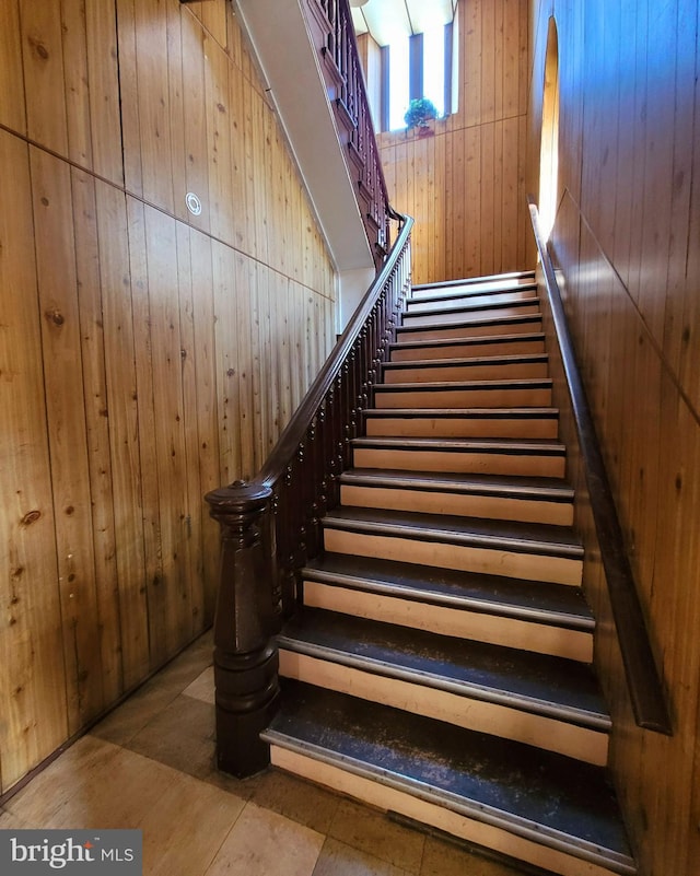 stairs featuring wooden walls