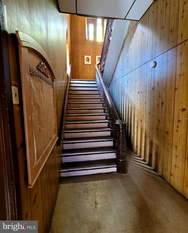 stairs featuring wooden walls