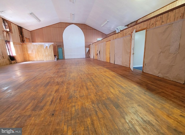 spare room featuring dark hardwood / wood-style flooring and lofted ceiling