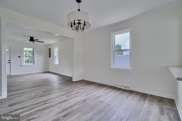 interior space with crown molding, ceiling fan with notable chandelier, and light hardwood / wood-style floors