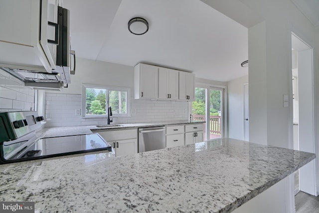 kitchen with appliances with stainless steel finishes, light stone countertops, sink, and white cabinets