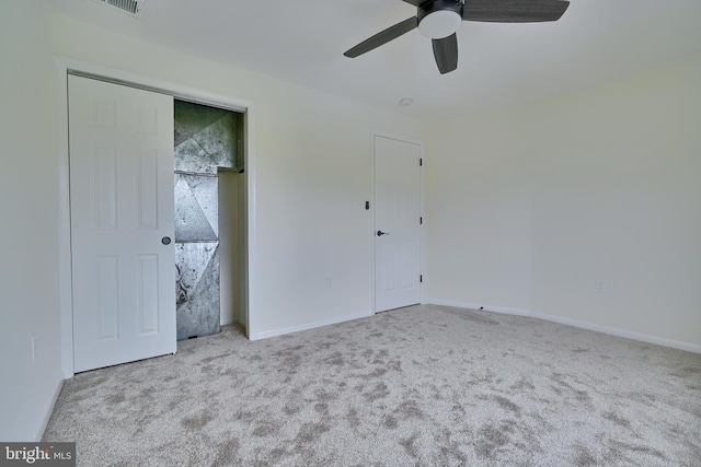 unfurnished bedroom with light carpet, ceiling fan, and a closet