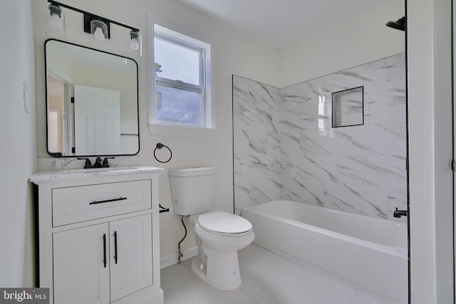 full bathroom with tiled shower / bath, vanity, and toilet