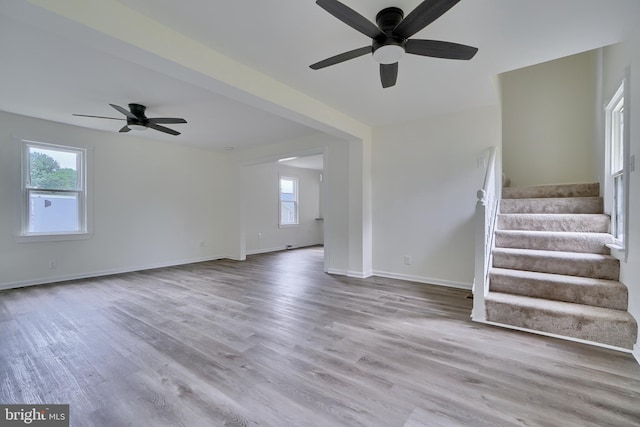 unfurnished living room with ceiling fan and light hardwood / wood-style flooring