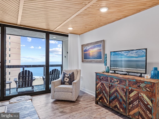 sitting room featuring hardwood / wood-style flooring, expansive windows, and wood ceiling