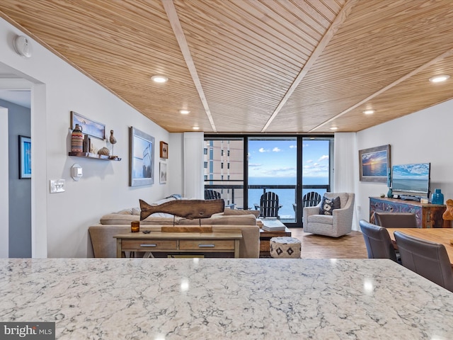 living room with wooden ceiling and expansive windows