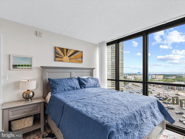 bedroom featuring floor to ceiling windows and a textured ceiling