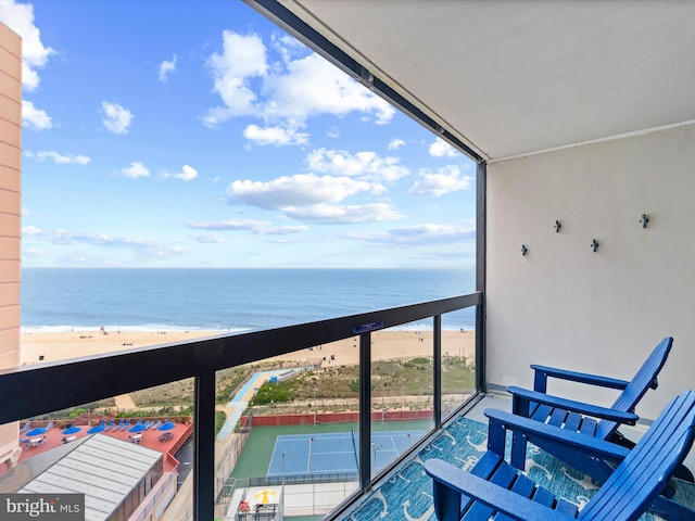 balcony with a water view and a beach view