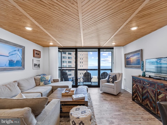 living room with expansive windows, hardwood / wood-style floors, and wooden ceiling