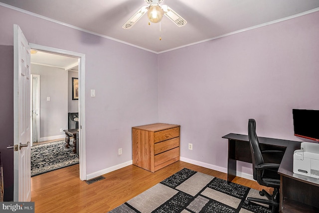 home office featuring hardwood / wood-style flooring, ceiling fan, and crown molding