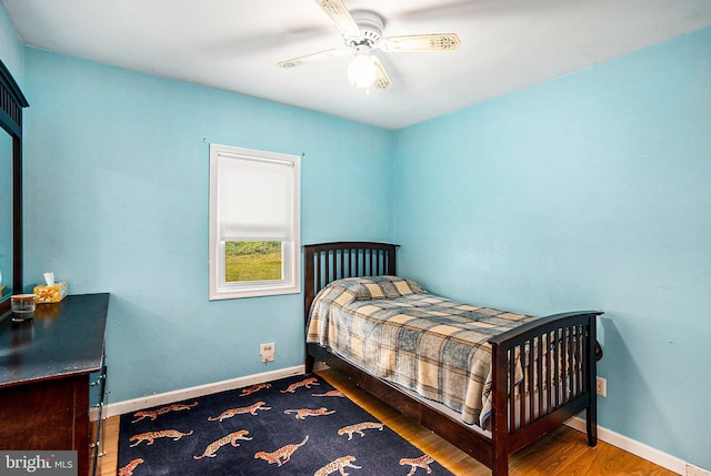 bedroom with hardwood / wood-style floors and ceiling fan