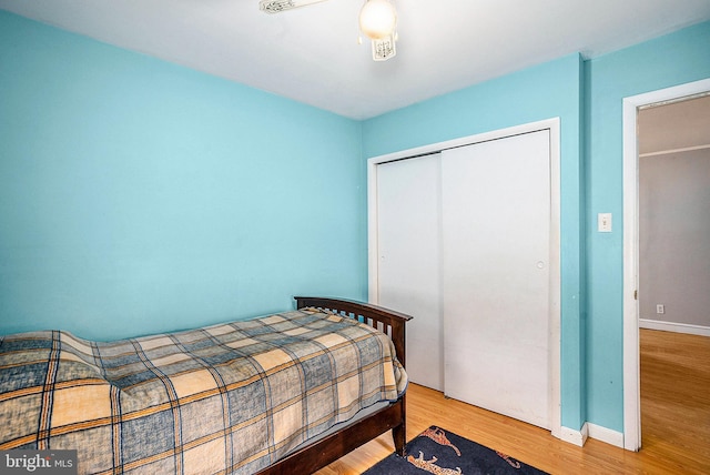 bedroom with wood-type flooring and a closet