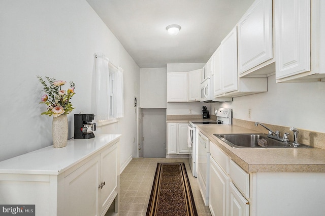 kitchen with stainless steel range with electric stovetop, white cabinets, and sink