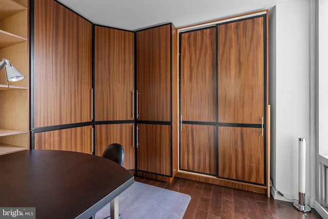 unfurnished office featuring dark hardwood / wood-style flooring