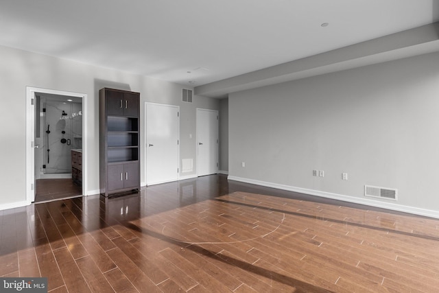 unfurnished room with dark wood-type flooring