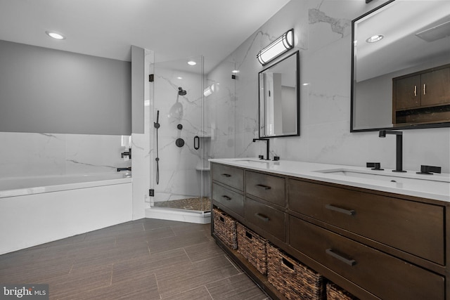 bathroom featuring shower with separate bathtub and vanity