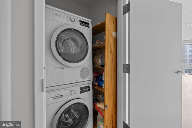 clothes washing area with stacked washer and dryer