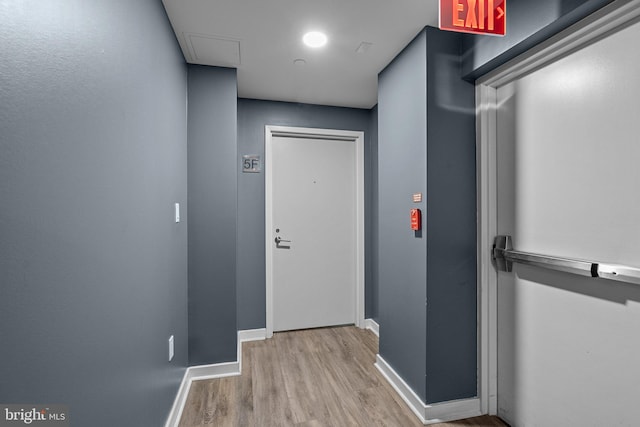 hallway with light hardwood / wood-style flooring