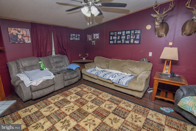 living room featuring hardwood / wood-style flooring, ceiling fan, a textured ceiling, and vaulted ceiling