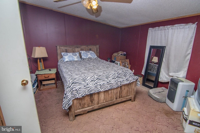 carpeted bedroom with ceiling fan and a textured ceiling