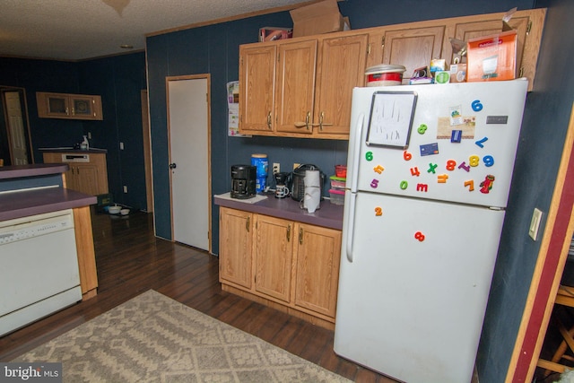 kitchen featuring white appliances and dark hardwood / wood-style floors