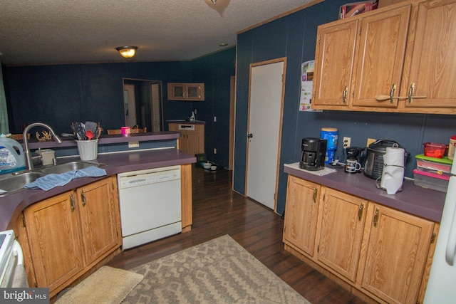 kitchen with dishwasher, sink, dark hardwood / wood-style floors, a textured ceiling, and lofted ceiling