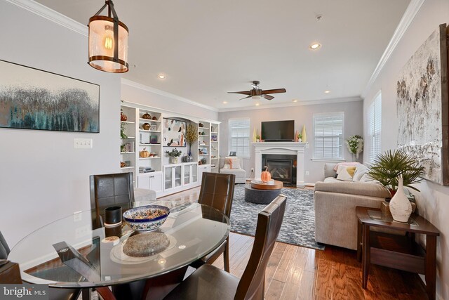 dining area with ornamental molding, dark hardwood / wood-style flooring, and ceiling fan