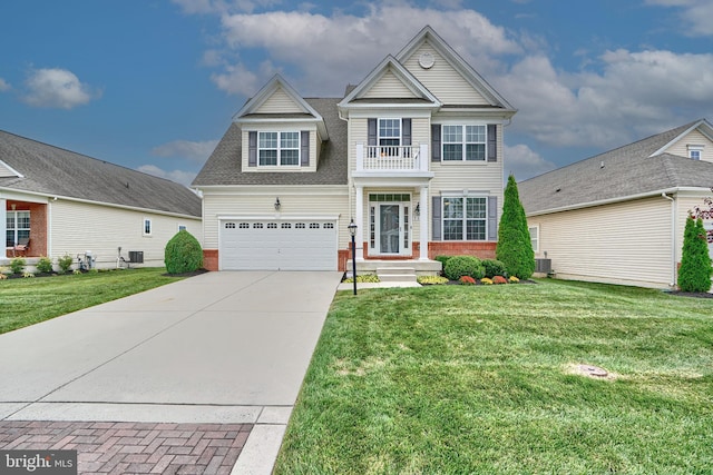 traditional home featuring a front yard, a balcony, brick siding, and driveway