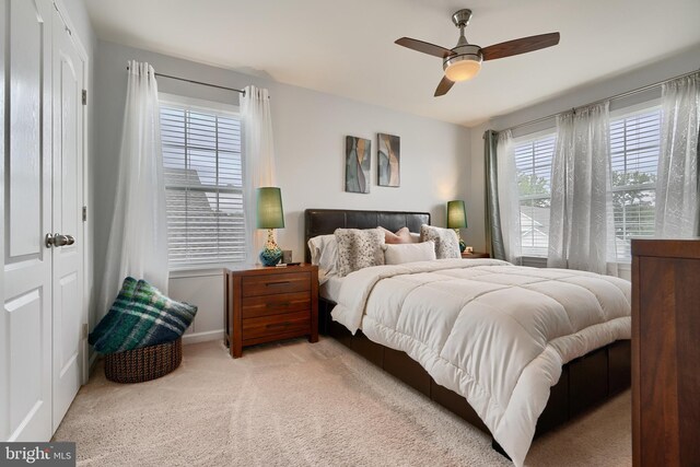 bedroom featuring ceiling fan and light colored carpet