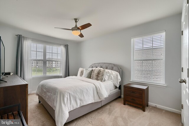 bedroom with ceiling fan and light colored carpet