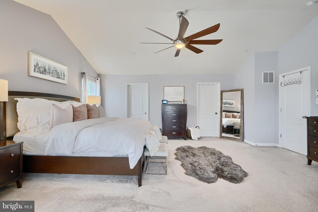 carpeted bedroom with vaulted ceiling and ceiling fan