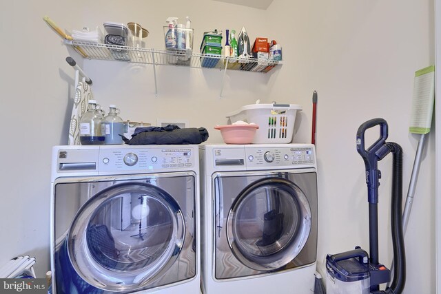 clothes washing area featuring washing machine and clothes dryer