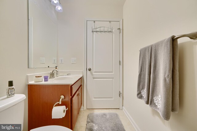 bathroom featuring vanity, toilet, and tile patterned floors