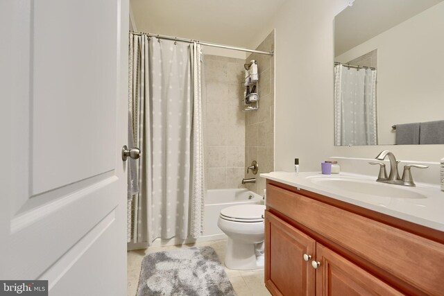 full bathroom with tile patterned flooring, shower / bath combo, vanity, and toilet