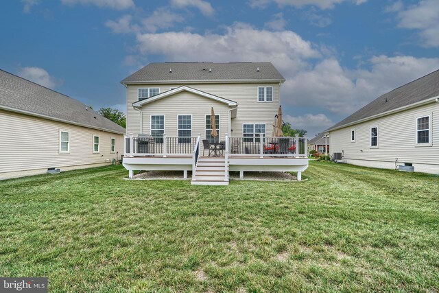 back of house featuring a deck, a yard, and central AC