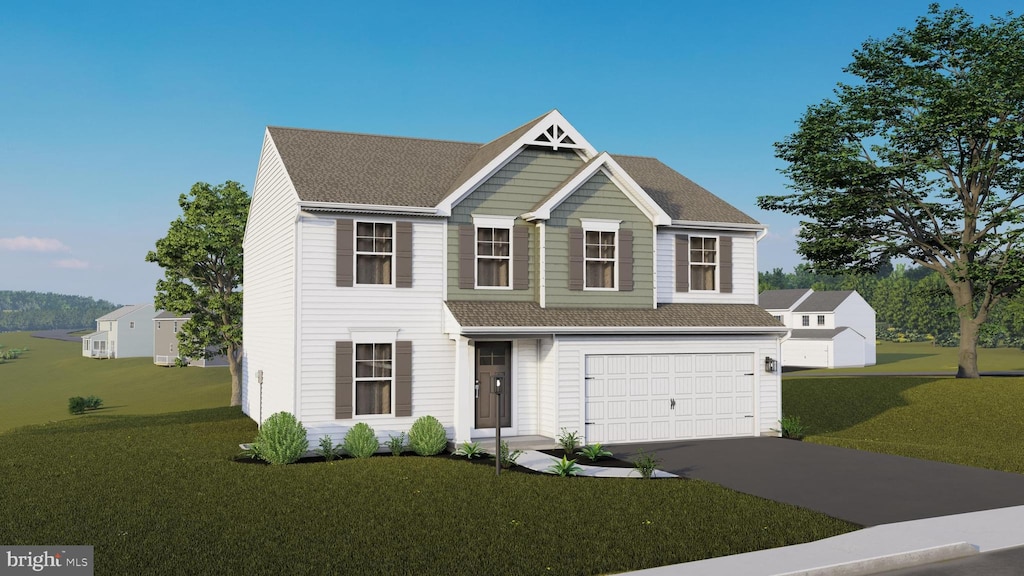 view of front of home featuring a front lawn and a garage