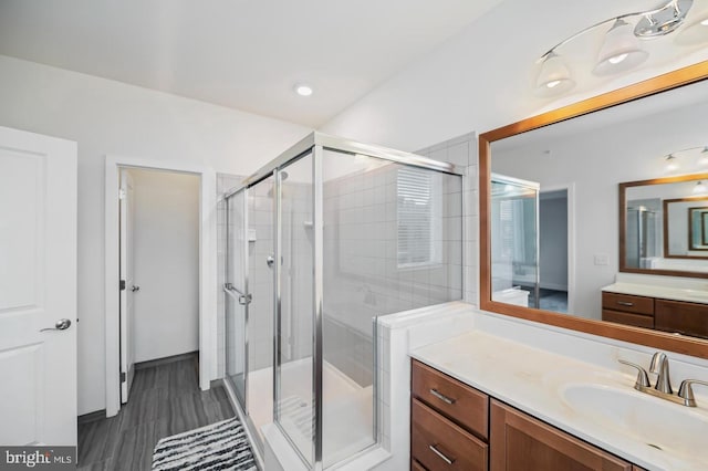 bathroom featuring vanity and an enclosed shower