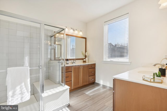 bathroom featuring vanity, wood-type flooring, and an enclosed shower