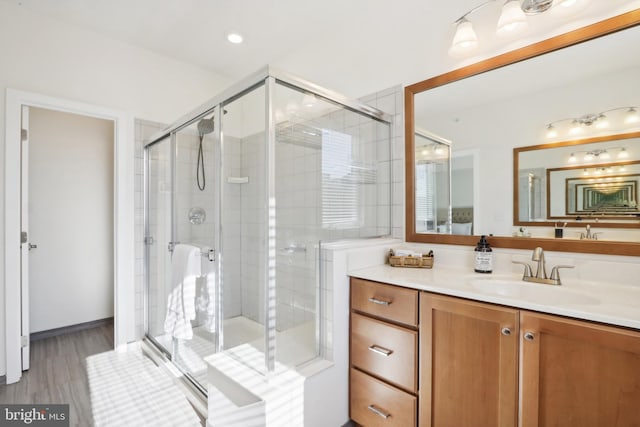 bathroom with vanity, wood-type flooring, and walk in shower