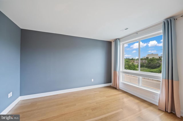 empty room with light hardwood / wood-style flooring