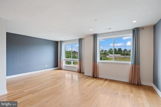 spare room featuring light wood-type flooring