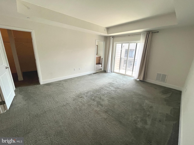 unfurnished room featuring dark carpet